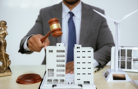 A lawyer specializing in real estate law handles property sales, mortgages, and litigation. They represent clients in court, advising on investments, taxes, and foreclosures, ensuring justice and prot