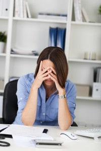 woman with head in hands